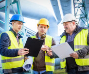 Image of people on a rig wearing safety helmets