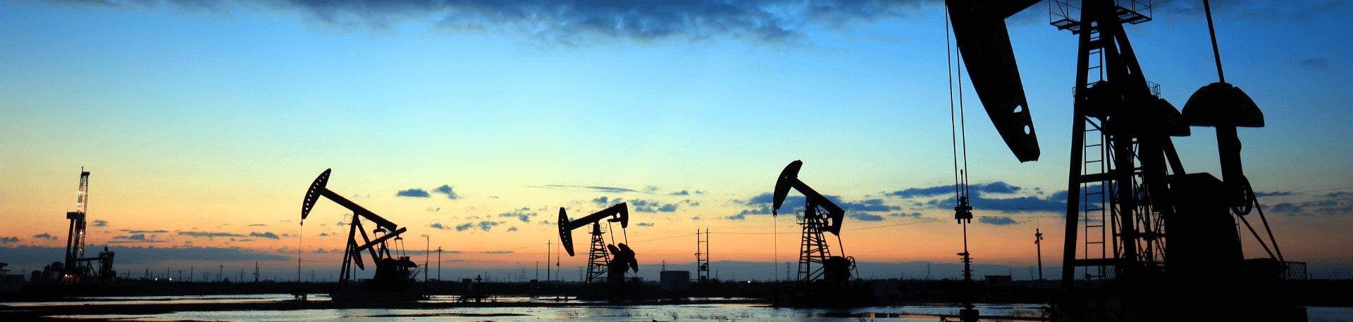 Image of oil rigs at sunset